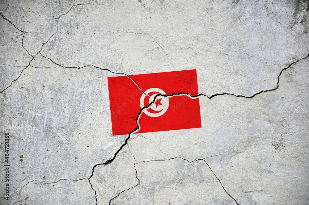 An old image of the flag of Tunisia on a wall with a crack.