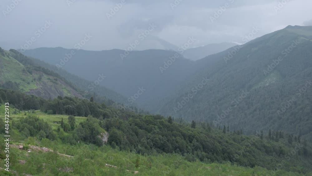Mountain landscape with green valleys. Silhouettes of mountains against the sky. Caucasian State Natural Biosphere Reserve named after Kh.G. Shaposhnikov. Lago-Naki plateau. Russia. Mountain landscape with green valleys. Silhouettes of mountains against the sky. Caucasian State Natural Biosphere Reserve named after Kh.G. Shaposhnikov. Lago-Naki plateau. Russia.