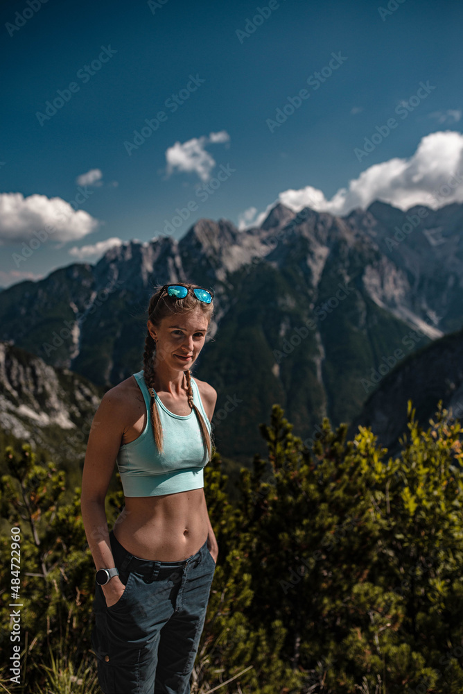 Young sporty woman posing during a hike in Julian Alps in beautiful Slovenia on a sunny September afternoon Young sporty woman posing during a hike in Julian Alps in beautiful Slovenia on a sunny September afternoon