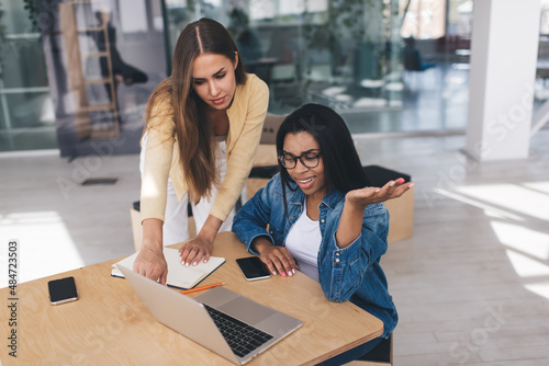 Business women working in open space office photo