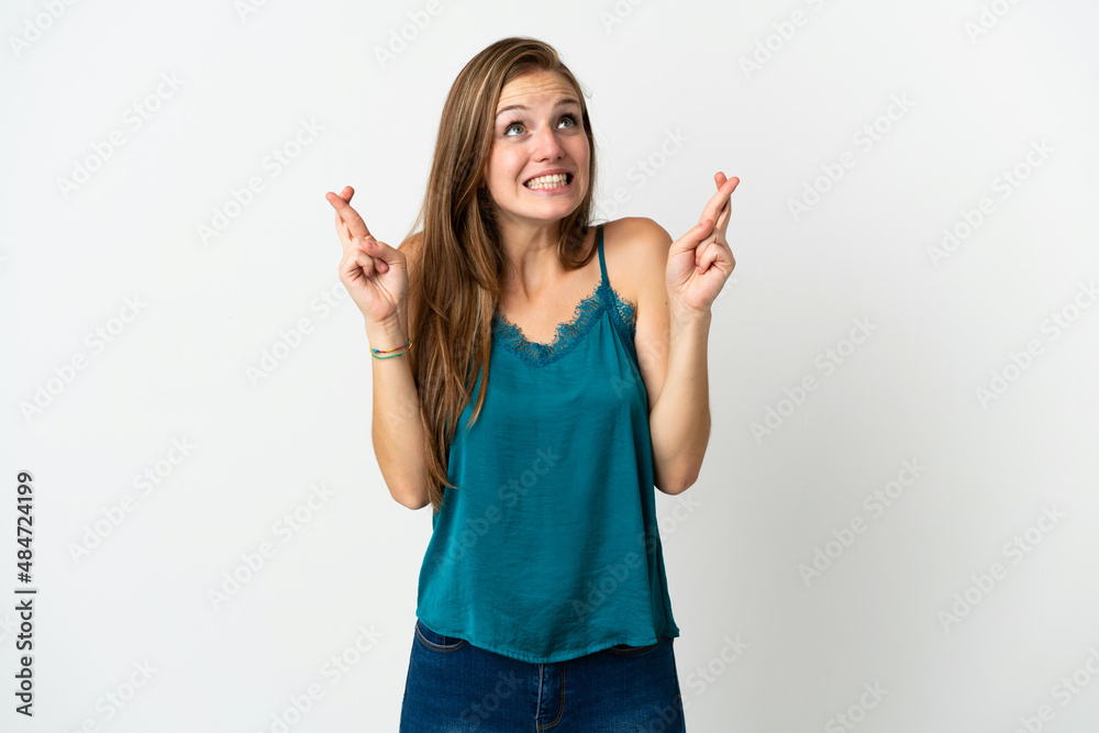 Young caucasian woman over isolated background with fingers crossing and wishing the best Young caucasian woman over isolated background with fingers crossing and wishing the best
