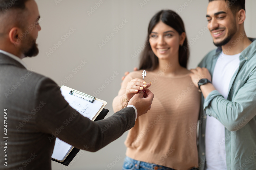 Real Estate Agent Giving Keys To Excited Buyers Real Estate Agent Giving Keys To Excited Buyers