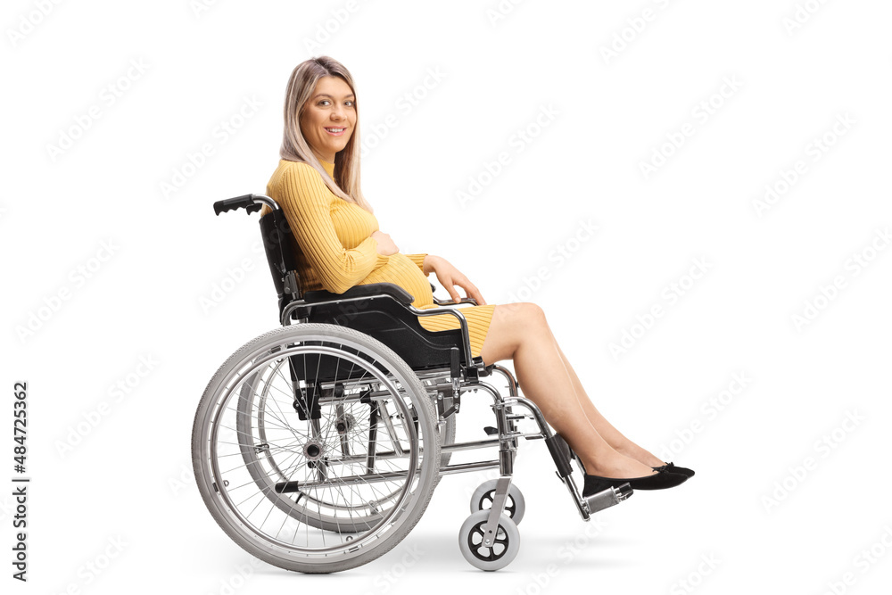 Full length profile shot of a pregnant woman sitting in a wheelchair and looking at camera Full length profile shot of a pregnant woman sitting in a wheelchair and looking at camera