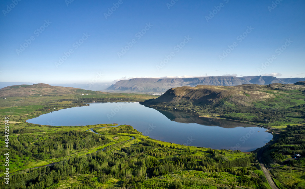 Pond in middle of mountainous valley Pond in middle of mountainous valley