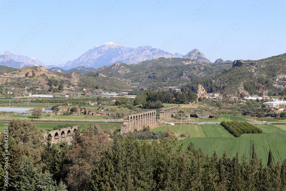 beautiful landscape with mountains, sky and Roman aqueduct of ancient city Aspendos in Turkey