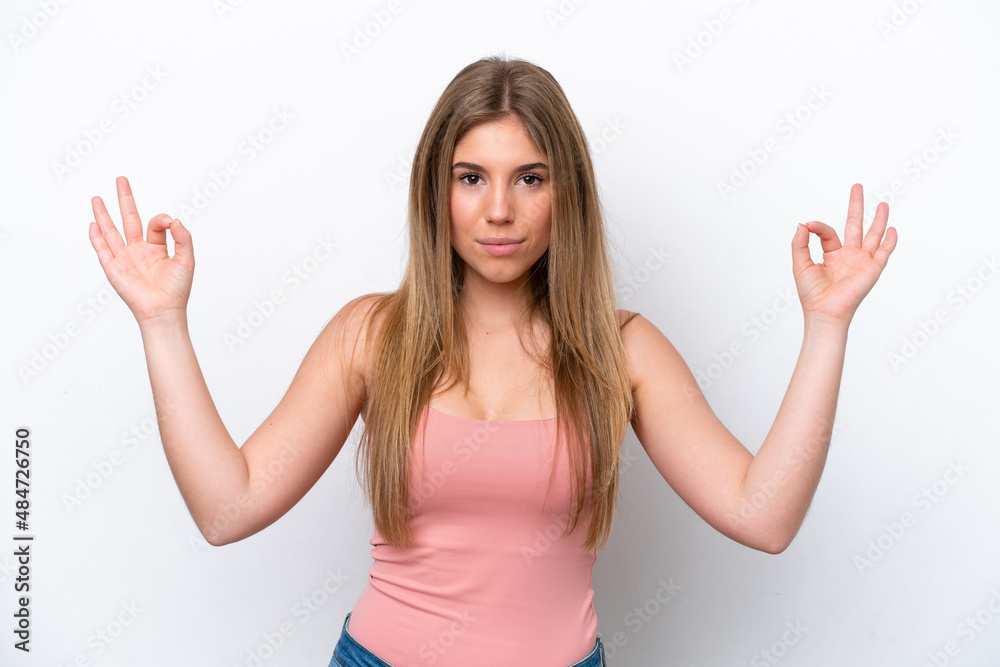 Young caucasian woman isolated on white bakcground in zen pose