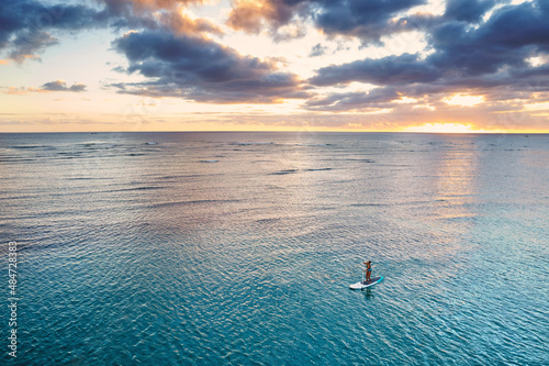 Sticker Ala Moana Beach Park in Honolulu, Hawaii at sunset, with paddle boarders and swi