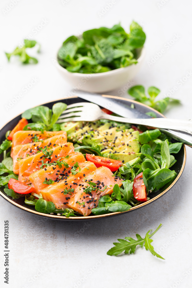Salmon fish fillet with fresh salad, avocado top view. Salmon fish fillet with fresh salad, avocado top view.
