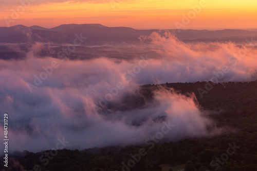 Colorful morning sunrise with golden glowing fog clouds over mountains at Arkansas Grand Canyon Scenic Point Overlook  © Lenspiration