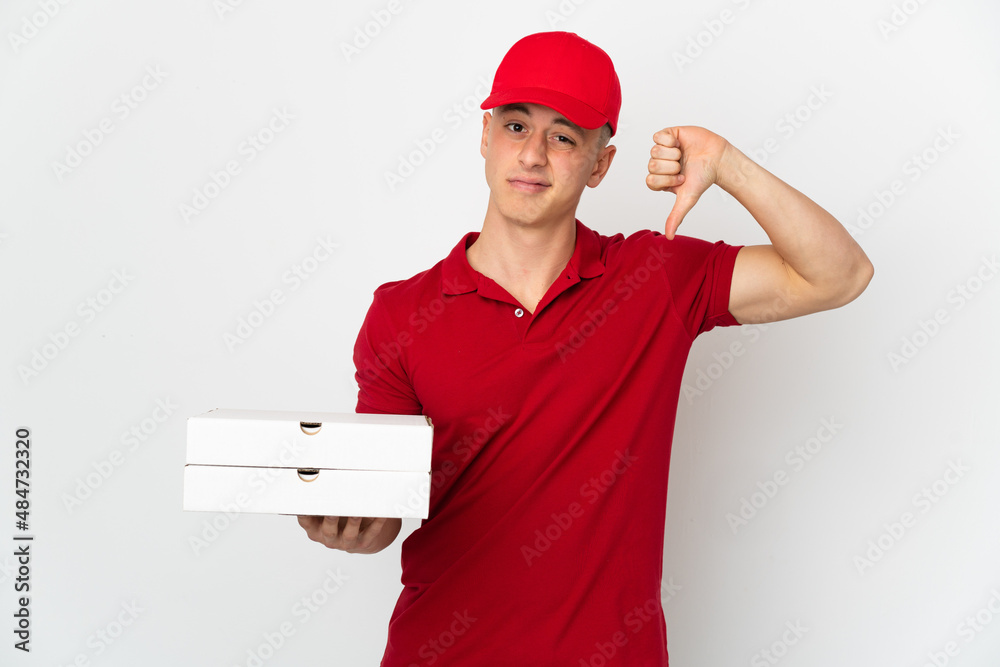 Pizza delivery man with work uniform picking up pizza boxes isolated on white background showing thumb down with negative expression Pizza delivery man with work uniform picking up pizza boxes isolated on white background showing thumb down with negative expression