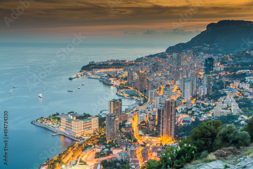 Fototapeta Naklejka Na Ścianę i Meble -  Aerial view of Monaco - Monte-Carlo at dusk, cityscape with night illumination, mountain, skyscrapers, mediterranean sea