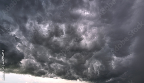 Landscape of dark ominous clouds like volcano eruption on stormy sky during heavy thunderstorm