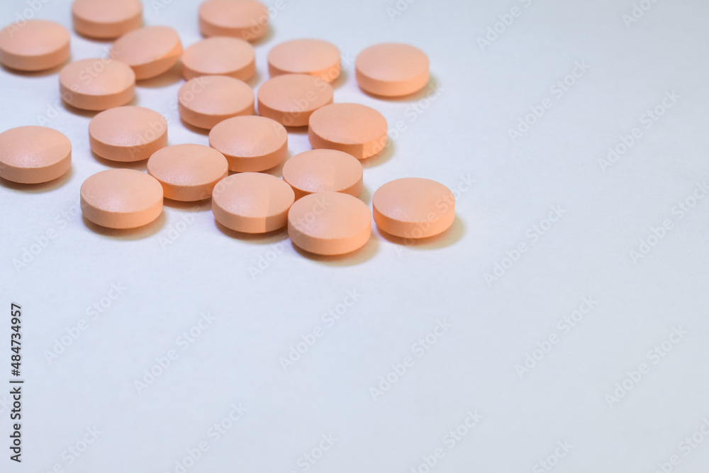 Orange pills on white background