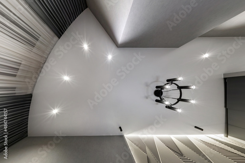 Fototapeta Naklejka Na Ścianę i Meble -  suspended ceiling with halogen spots lamps and drywall construction in empty room in apartment or house. Stretch ceiling white and complex shape.