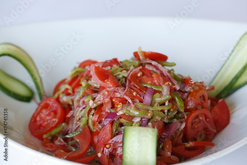 Vegan feed with different herbs and tomato salad.