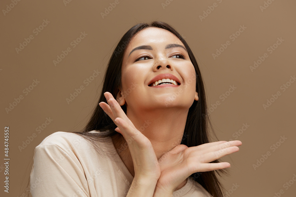 portrait woman in a beige T-shirt posing clothing fashion beige background portrait woman in a beige T-shirt posing clothing fashion beige background
