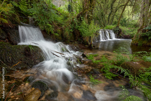 Small waterfalls formed by the river Tripes in the natural park of Mount Aloia Park, in the area of Galicia, Spain. photo