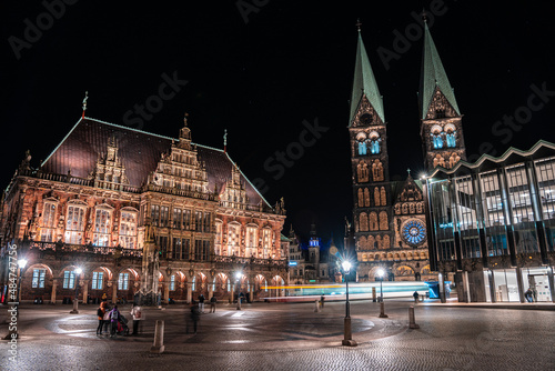 Bremen cathedral Bremer Dom and town hall Bremer Rathaus with Roland in front. Night with motion on central square of northern germen city. Illuminated historical buildings.