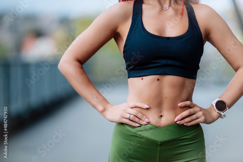 Details of fitness trainers body, woman fit body with perfect abs