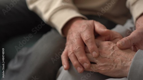 Real feelings. Close up of hands of nice elderly people being held together. Senior old couple husband and wife holding hands close up view, mature elderly family