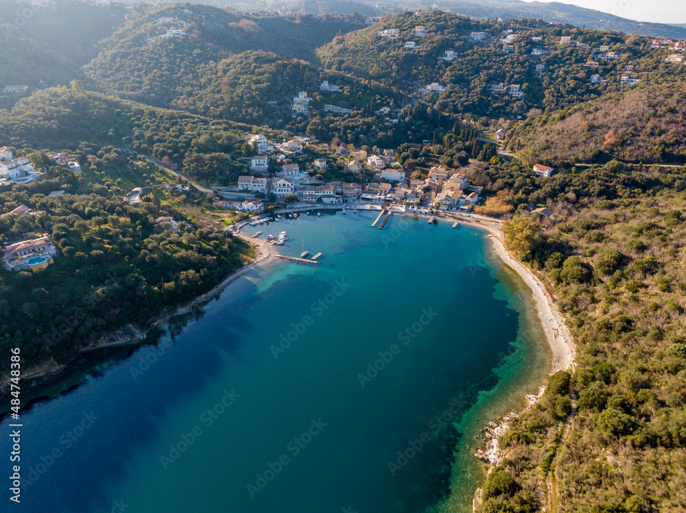 Agios Stefanos bay, one of the most beautiful fishing villages in Corfu Island. Kerkyra, Greece. Aerial drone  view.