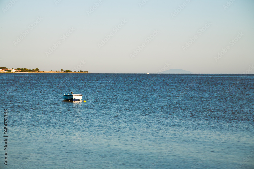 Small fishing boat moored on a sea