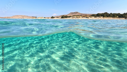 Fototapeta Naklejka Na Ścianę i Meble -  Underwater split photo of paradise beach of Simos in island of Elafonisos, Lakonia, Greece