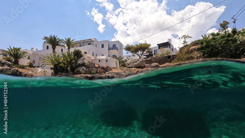 Underwater split photo of small bay and pituresque village of Avlemonas with emerald crystal clear sea in island of Kythira, Ionian, Greece