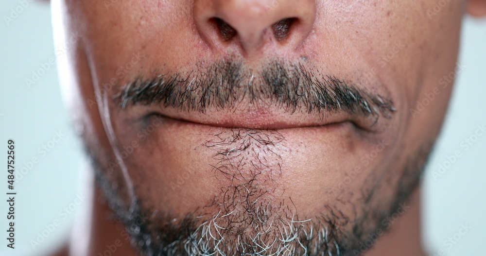 Obraz premium Man with mouth zipped, lips pressed close-up, feeling anxiety