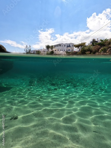 Underwater split photo of small bay and pituresque village of Avlemonas with emerald crystal clear sea in island of Kythira  Ionian  Greece