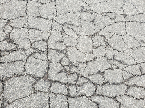 Texture cracks in the asphalt of the road