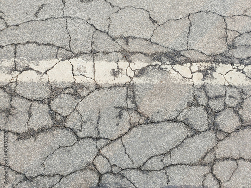Texture cracks in the asphalt of the road