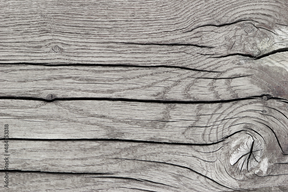 Textured background of gray sawn wood with cracks, horizontal lines, top view, close-up. Textured background of gray sawn wood with cracks, horizontal lines, top view, close-up.