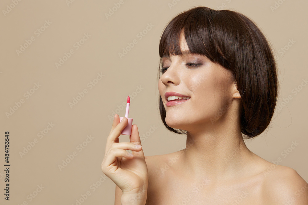 woman makeup lip gloss near the face bare shoulders cropped view woman makeup lip gloss near the face bare shoulders cropped view