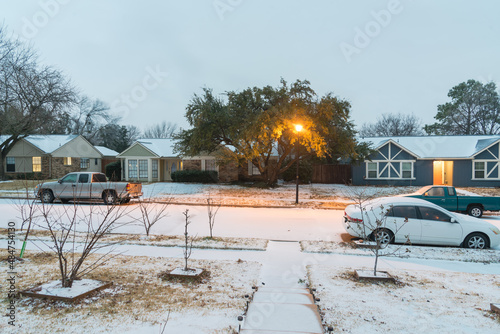 Heavy snow covered residential street in early morning with light pole at Dallas, Texas, America