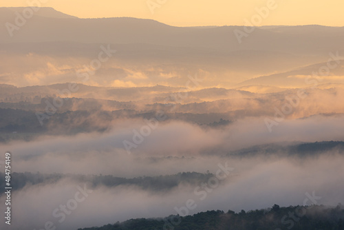 Foggy cloudy mist with sunrise glow over Grand Canyon mountains in Arkansas © Lenspiration