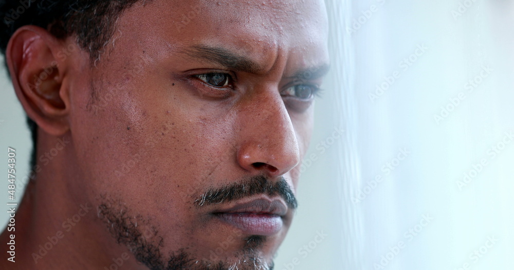 Concentrated African american thinking about solution, pensive black person portrait face