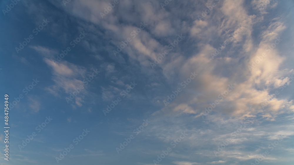 Fantastic bright clouds in the sunset sky. 
Sky background.