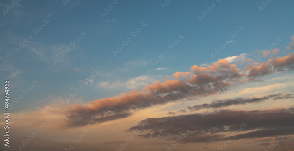 Fototapeta premium Fantastic bright clouds in the sunset sky. Sky background.