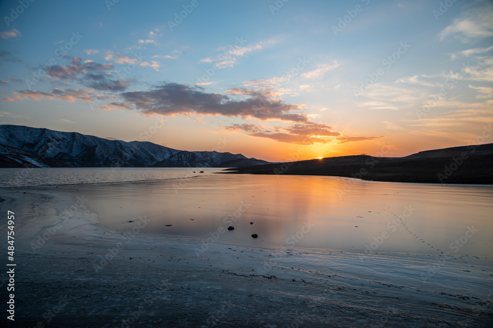 Beautiful landscape. Small lake and mountains at the sunset with dramatic clouds. Beautiful landscape. Small lake and mountains at the sunset with dramatic clouds.