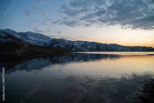 Beautiful landscape. Small lake and mountains after sunset with dramatic clouds. © Inga Av