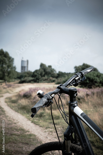Bike on path heading towards tower in distance, Rushmere, Suffolk, UK
