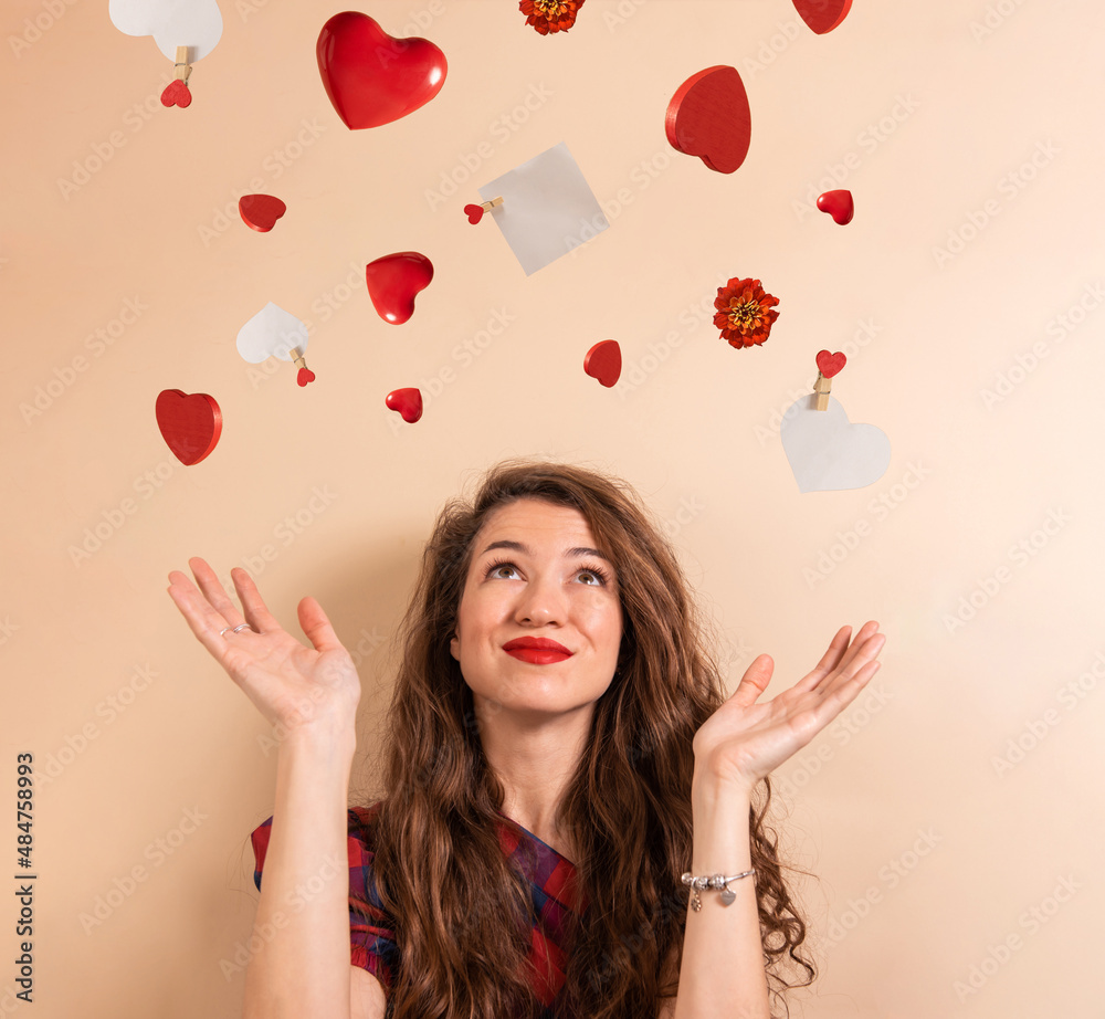 Creative portrait of young woman with hearts and paper card note on pastel background. Velentine's day Creative portrait of young woman with hearts and paper card note on pastel background. Velentine's day
