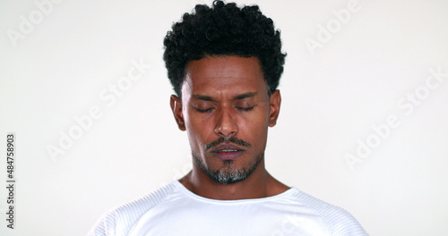 African man eyes closed remembering past experiences feeling upset pensive and frustration