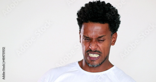 African man disgust face reaction. Black guy feeling dislike