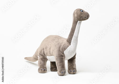 Brontosaurus dinosaur plush toy side view isolated on white background © Brett