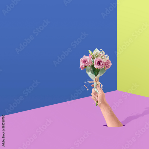 Creative pop art concept of romantic gift, a bouquet of flowers between two in love through the walls. Valentine modern poster background with copy space.