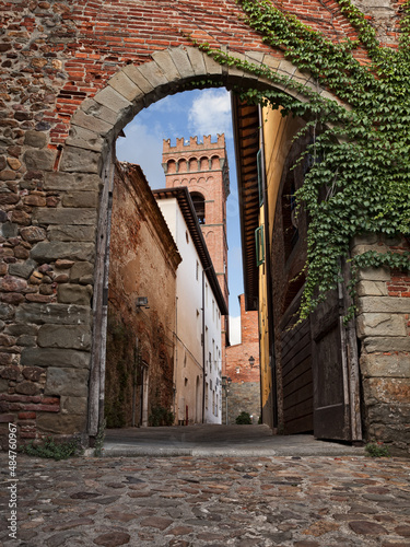 Montecarlo, Lucca, Tuscany, Italy: view of the old town gate with the narrow alley and the bell tower of the ancient church