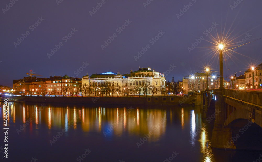 Night city landscape, reflection of street lights in the river, bridge