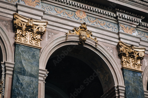 Obraz na plátně Arch and pilasters with gold Corinthian capitals inside the Jesuit Cathedral in Lviv, Ukraine